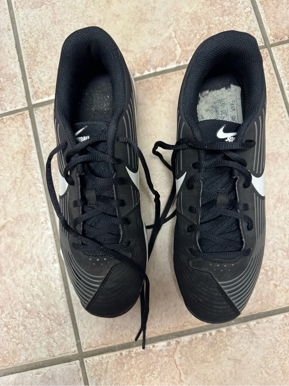 Nike Women’s Black cleats with White Swoosh